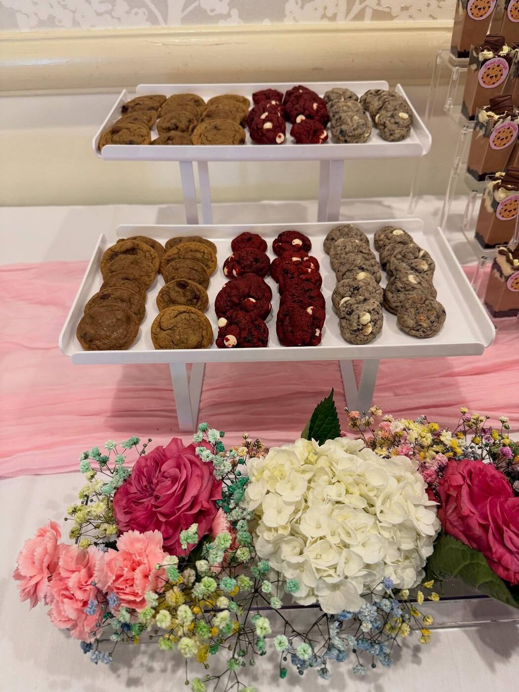 Trays of chocolate chip, red velvet, and oreo cookies